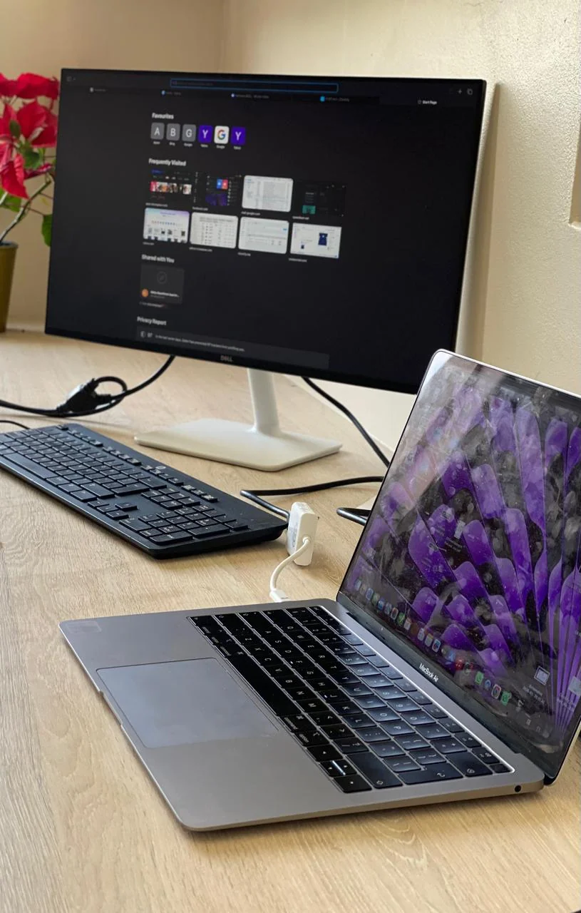 Social media content creation with laptop and phone on aesthetic desk setup